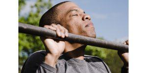 man doing pull ups on wall mounted pull up bar