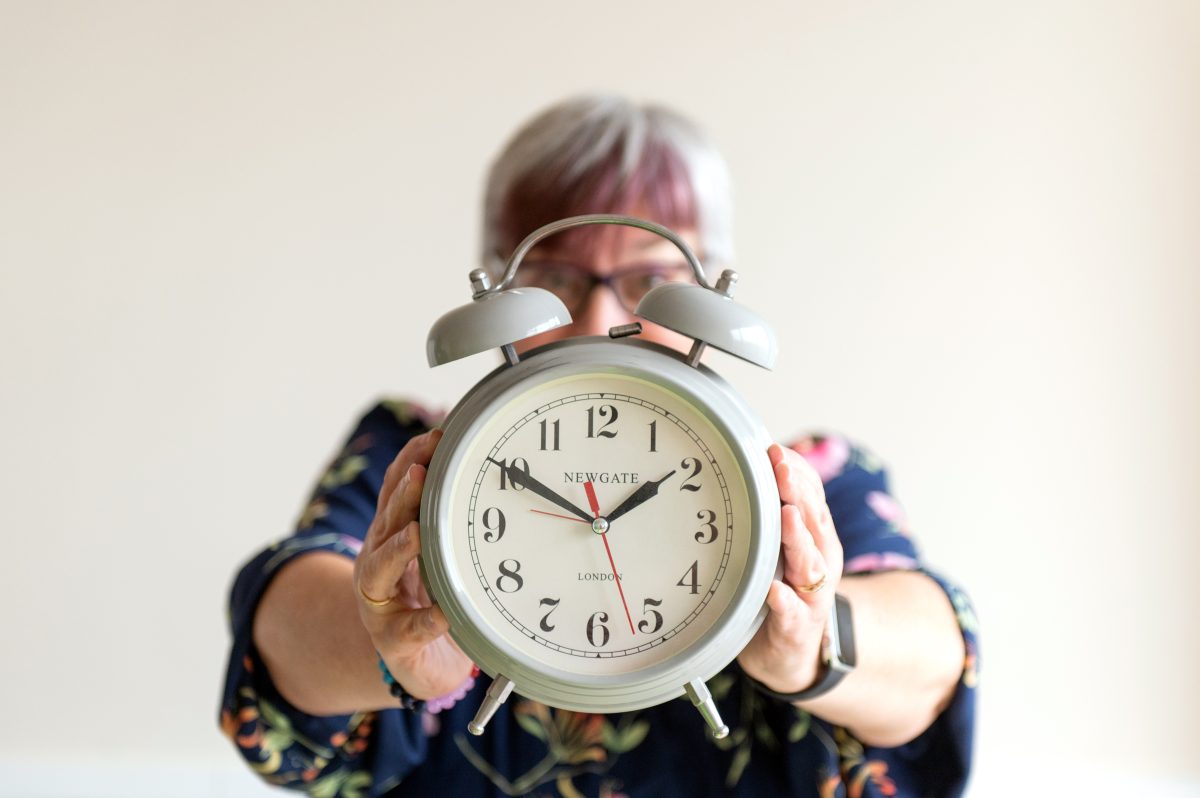 Journalist & PR consultant Fiona Scott holding an old-fashioned alarm clock Journalist & PR consultant Fiona Scott holding an old-fashioned alarm clock