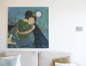 White living room interior with paintings.