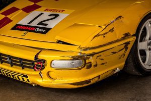 Yellow racing Ferrari with broken bumper Yellow racing Ferrari with broken bumper