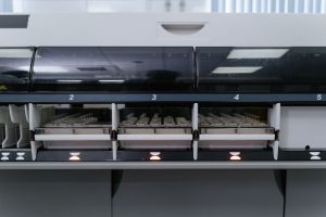 Automated laboratory machine analyzing multiple test samples in healthcare research facility