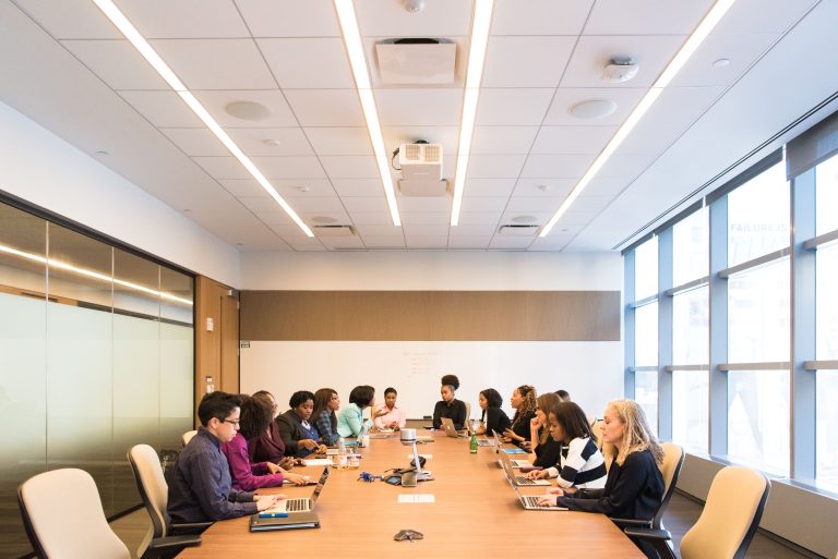 business leaders discussing sustainability and climate strategy at conference table