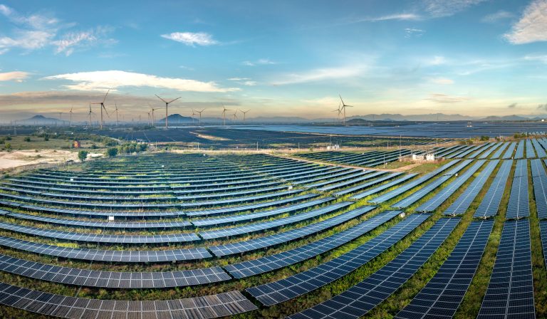 solar panels and wind turbines representing clean technology solutions
