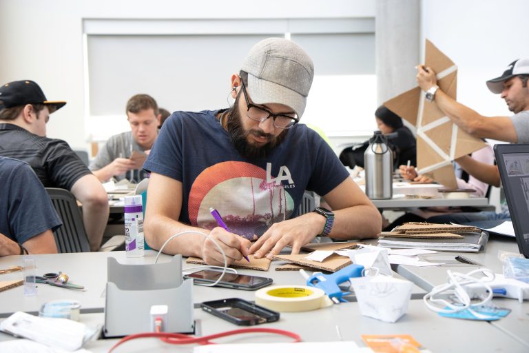 graduate researchers collaborating on technical research in laboratory
