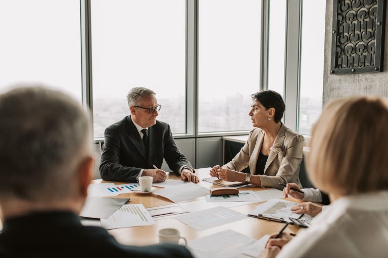 Business professionals engaged in a strategic meeting in a modern office setting with natural light