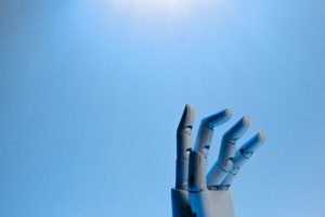 Articulated robotic hand against a blue background