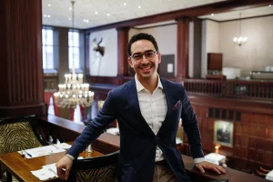 AppliedAI founder Arya Bolurfrushan poses for a portrait in a wood-paneled interior