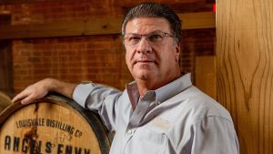 Wes Henderson beside an Angels Envy whiskey barrel
