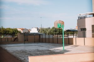 Empty outdoor basketball court with two hoops
