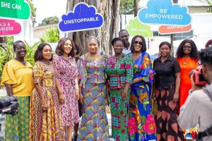 Women entrepreneurs in colorful outfits gather outdoors for a WeRise Network event in Ghana.