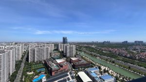 Aerial shot over Hai Phong, Vietnam, showcasing modern high-rise buildings under a clear sky