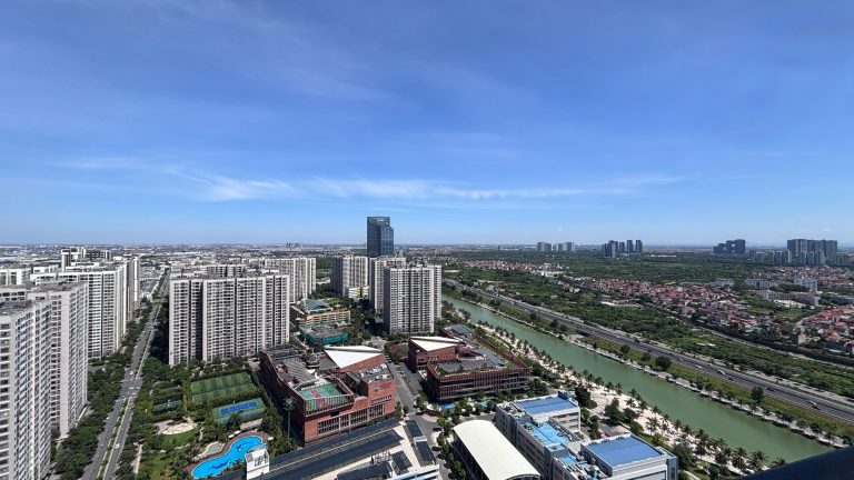 Aerial shot over Hai Phong, Vietnam, showcasing modern high-rise buildings under a clear sky