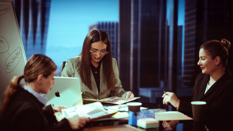 Three businesswomen engaged in a meeting inside a contemporary office