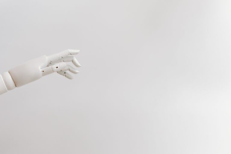 White robotic hand against a pale background