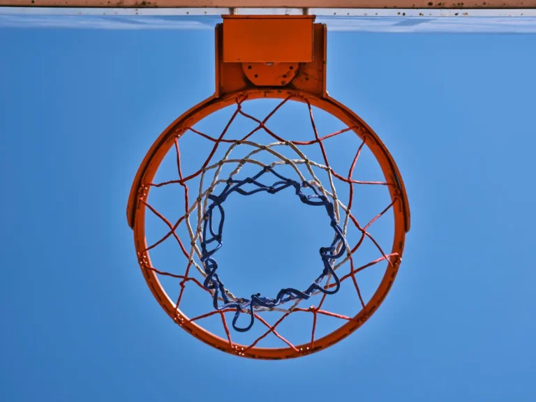 Basketball hoop and net against a blue sky