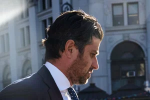 777 Partners co-founder Josh Wander in a dark suit outside a city building