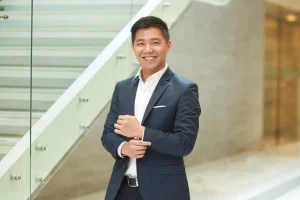 Astro co-founder Vincent Tjendra wearing a dark suit beside a staircase